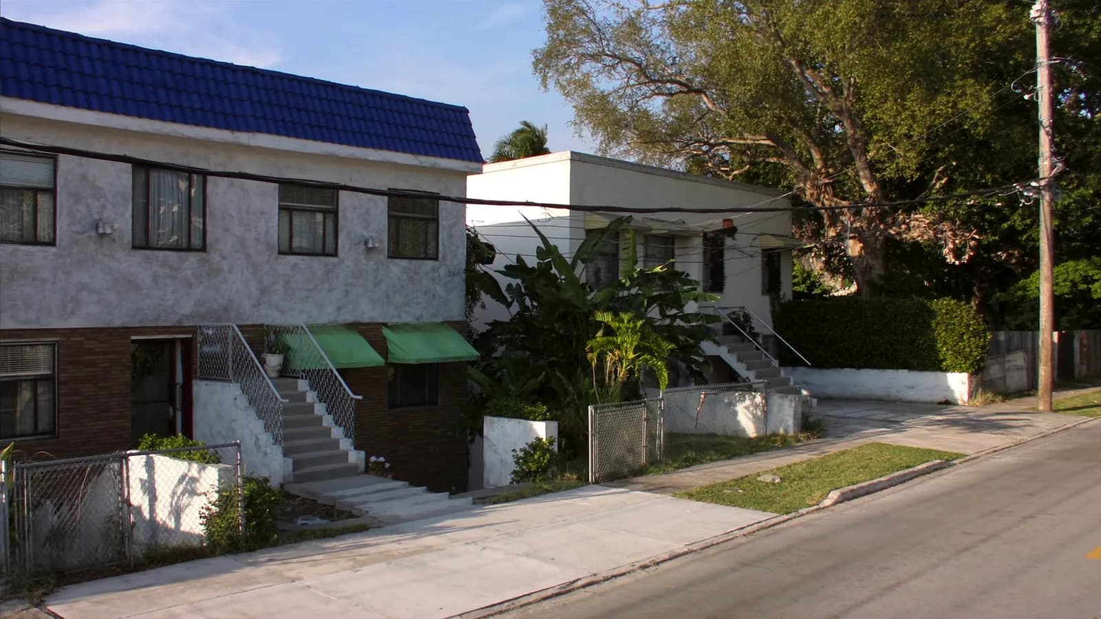 Older residential street of masonry homes and duplexes in inner-city Miami, Florida