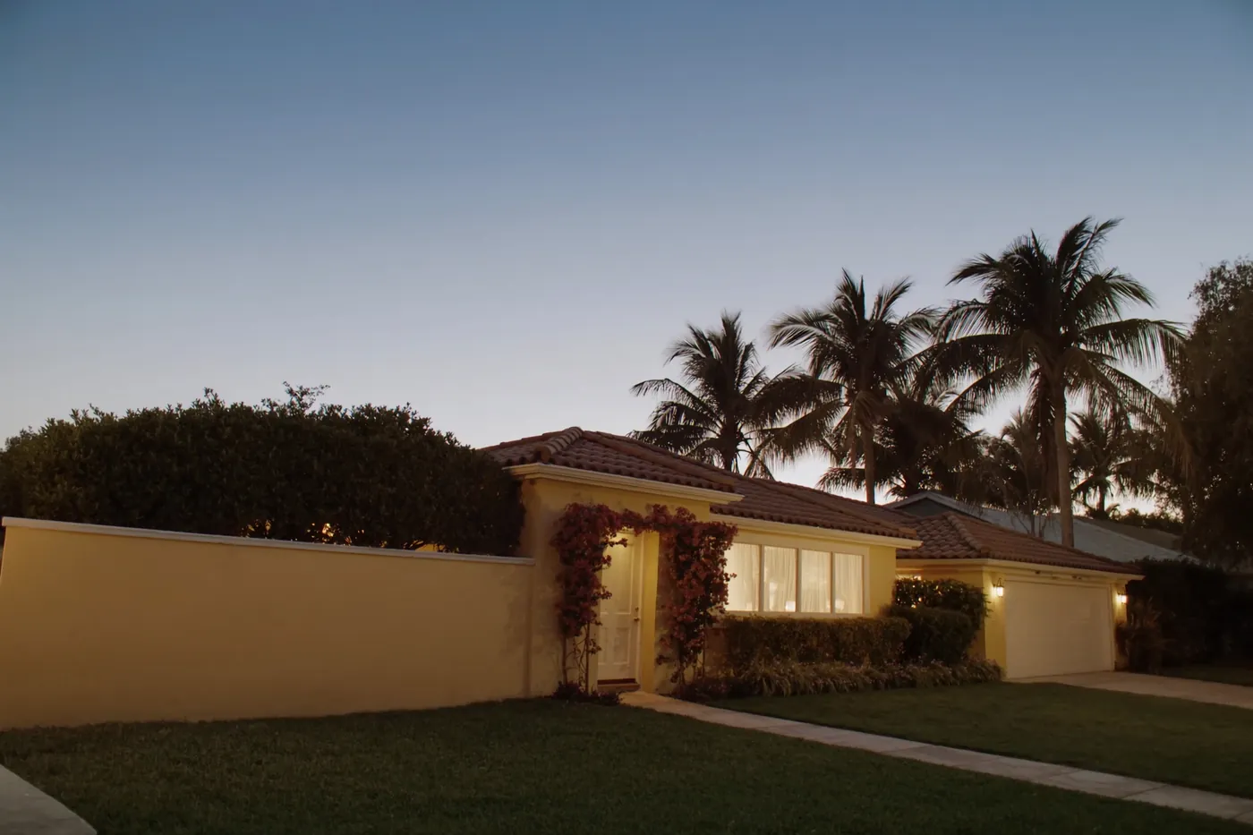 A well-presented South Florida home exterior at dusk
